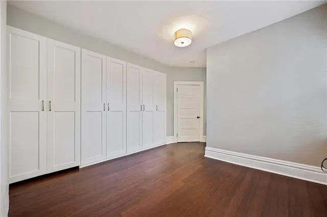 a view of an empty room and wooden floor