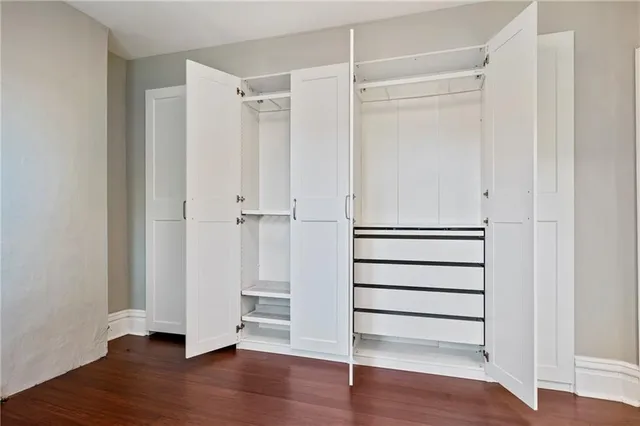 a view of walk in closet with empty racks