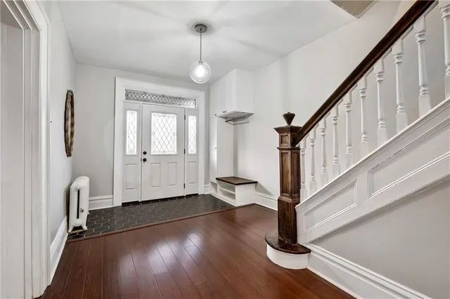 a view of entryway and hall with wooden floor