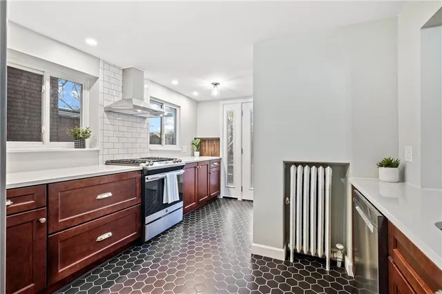a kitchen with granite countertop wooden cabinets and white appliances