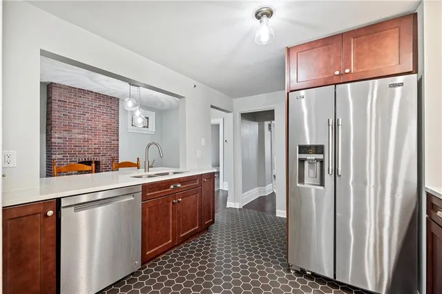 a kitchen with stainless steel appliances granite countertop a refrigerator and a sink