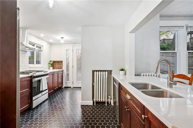 a kitchen with granite countertop a sink and a stove top oven