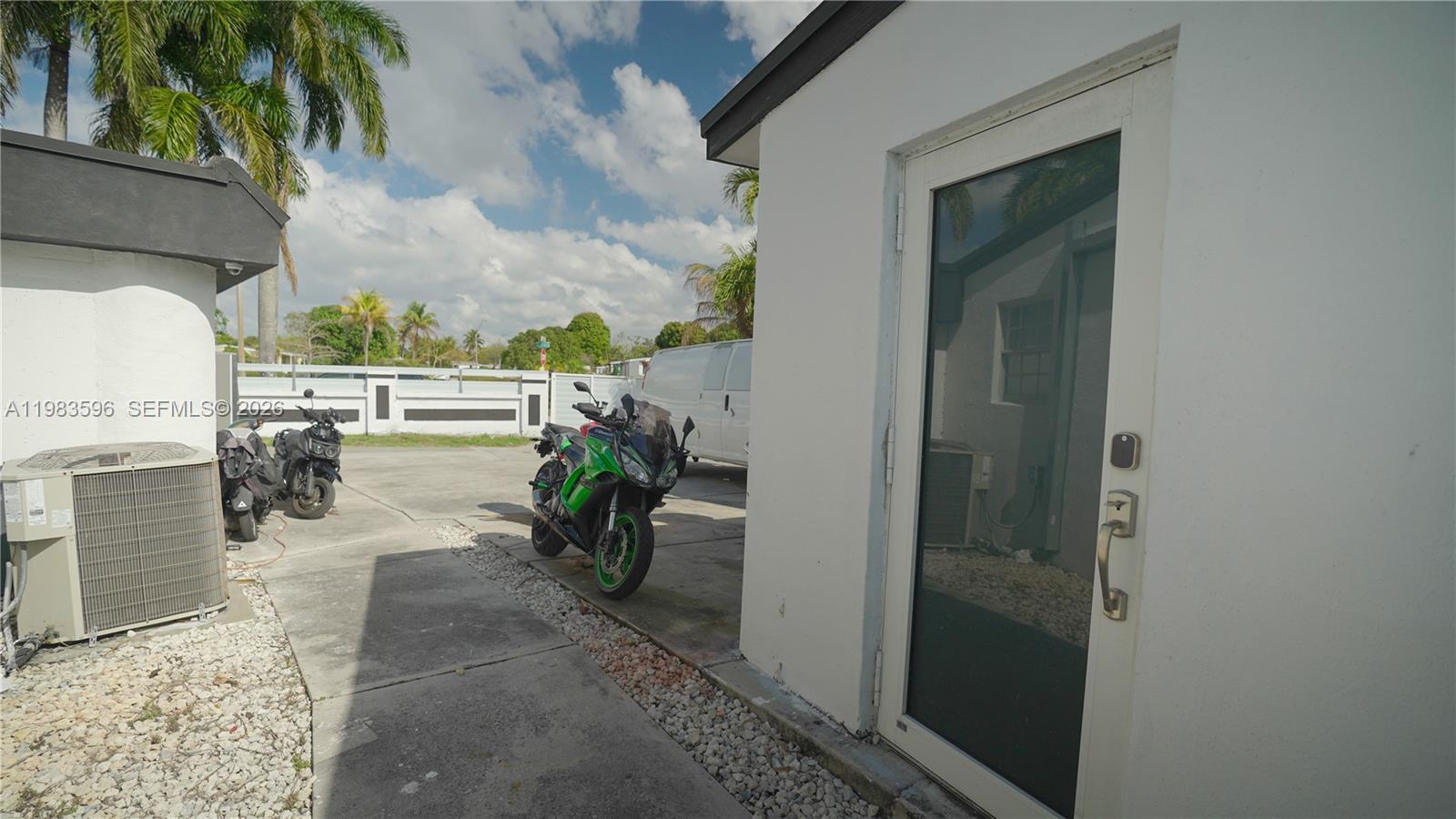 1720 Northwest 124th Terrace Miami, FL 33167 - Photo 13 of 73 a view of a porch with chairs and potted plants