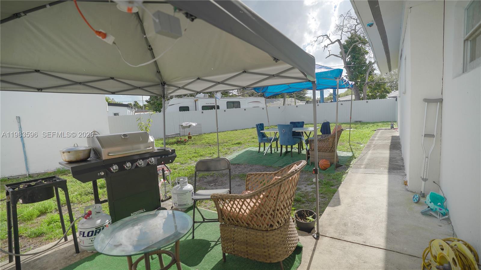 1720 Northwest 124th Terrace Miami, FL 33167 - Photo 18 of 73 a patio with a table and chairs