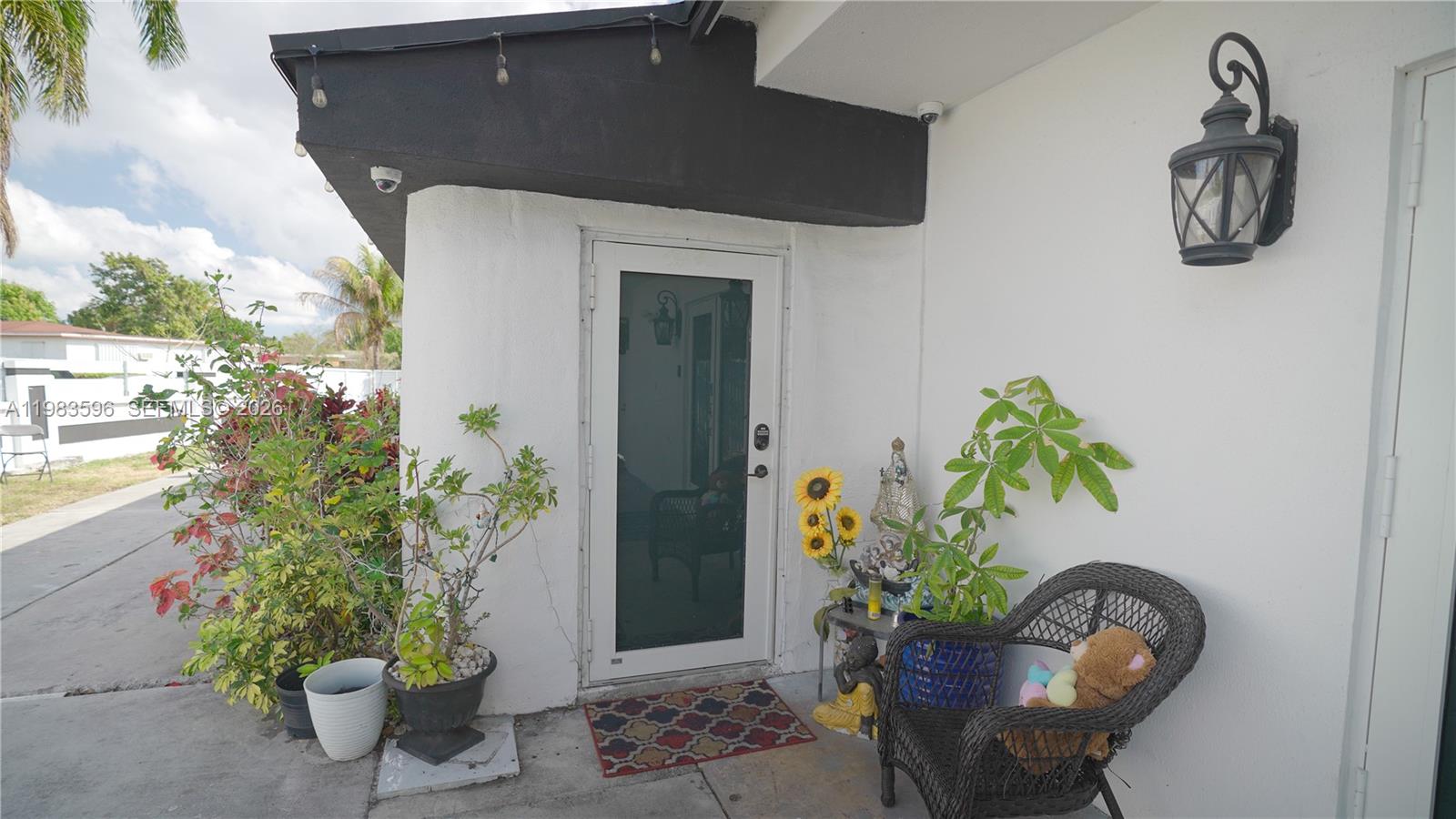 1720 Northwest 124th Terrace Miami, FL 33167 - Photo 20 of 73 a potted plant sitting in front of a house