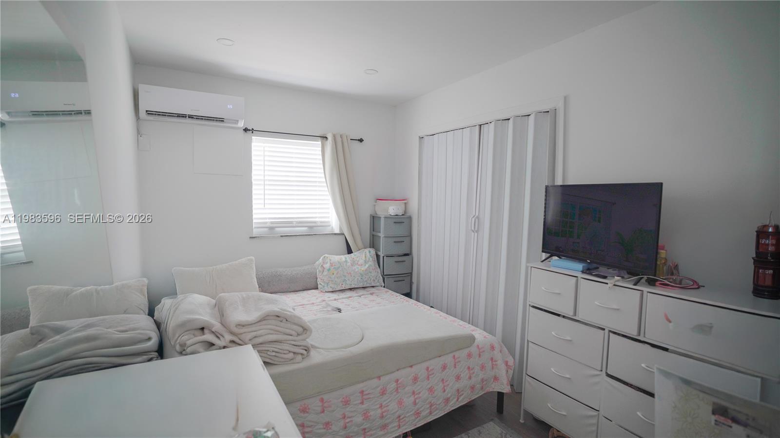 1720 Northwest 124th Terrace Miami, FL 33167 - Photo 29 of 73 a bedroom with a bed and a flat screen tv