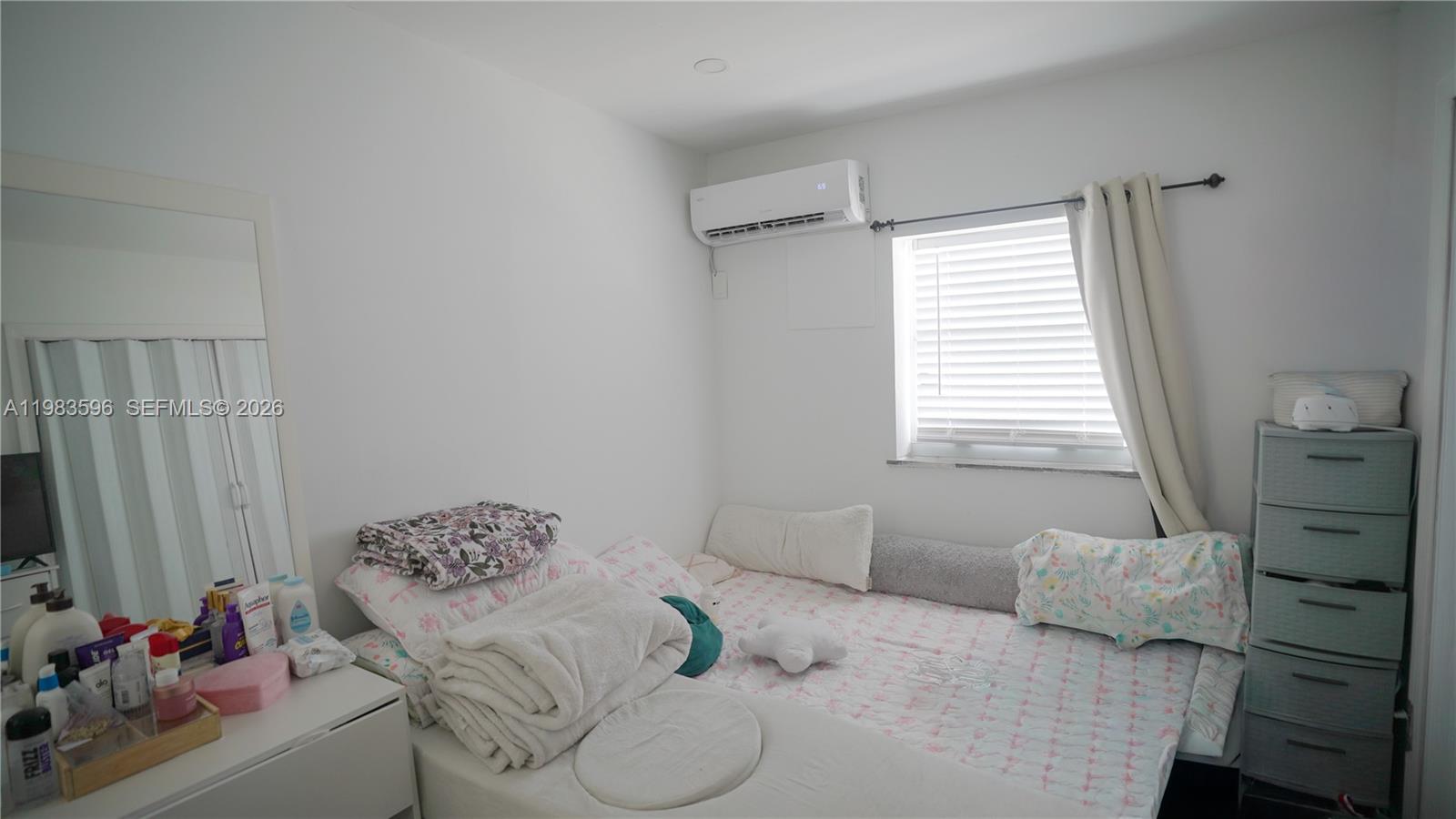 1720 Northwest 124th Terrace Miami, FL 33167 - Photo 31 of 73 a bedroom with a bed and a window