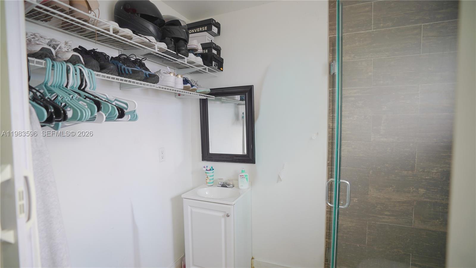 1720 Northwest 124th Terrace Miami, FL 33167 - Photo 37 of 73 a bathroom with a sink a mirror and shower