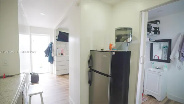 a view of a dining room with furniture and a kitchen