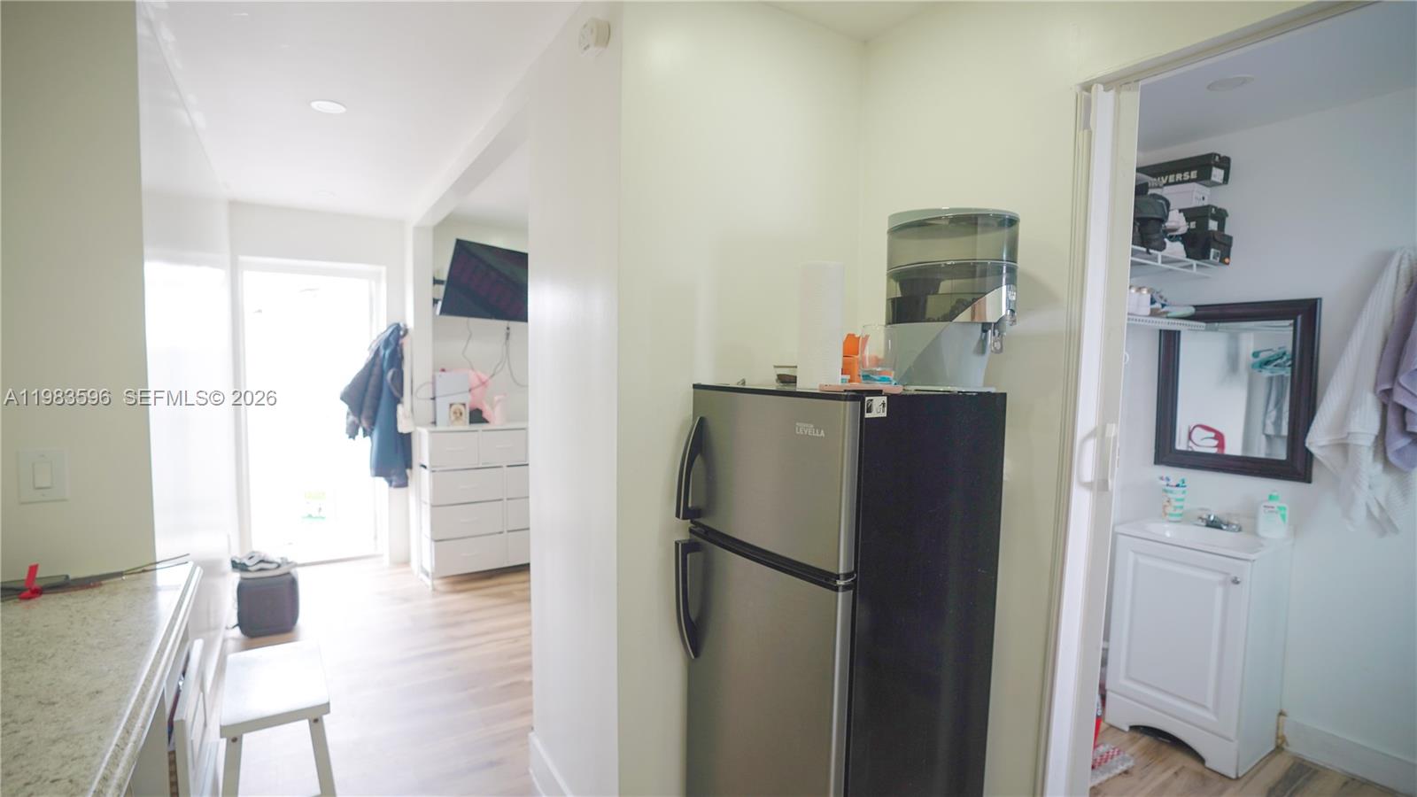 1720 Northwest 124th Terrace Miami, FL 33167 - Photo 38 of 73 a kitchen with stainless steel appliances a refrigerator and a wooden floor