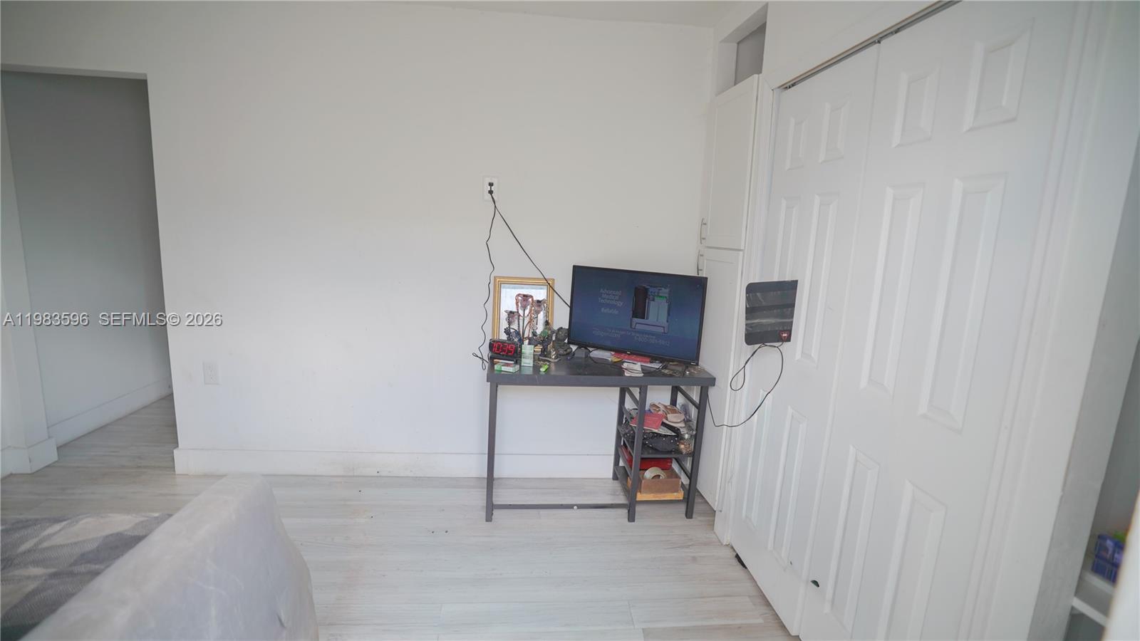 1720 Northwest 124th Terrace Miami, FL 33167 - Photo 39 of 73 a view of a livingroom with wooden floor and a flat screen tv