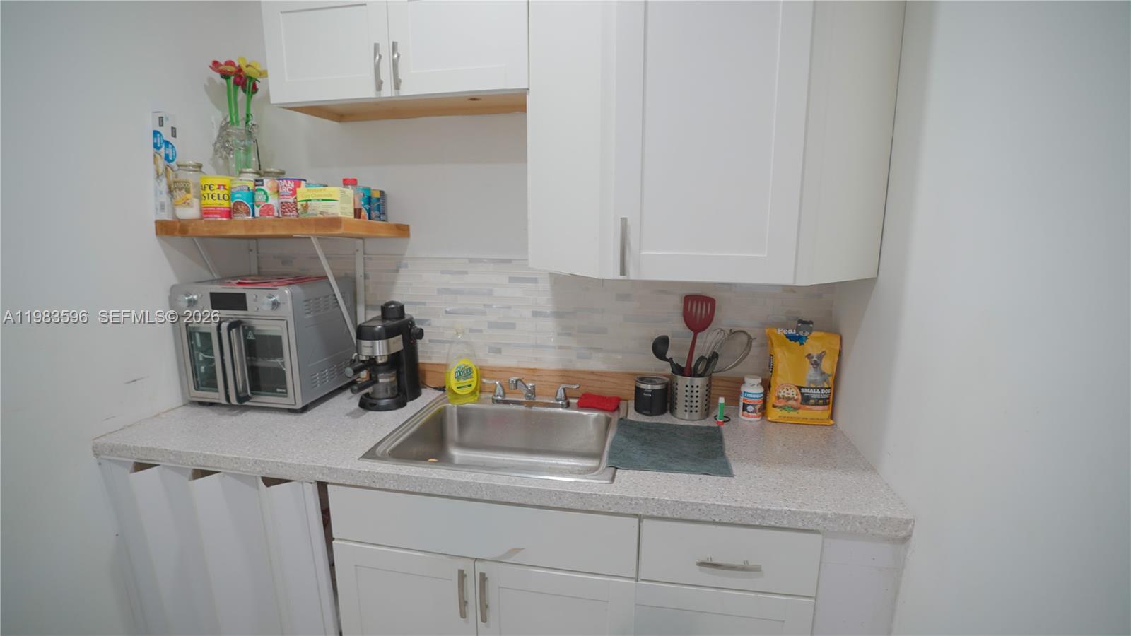 1720 Northwest 124th Terrace Miami, FL 33167 - Photo 44 of 73 a kitchen with a sink cabinets and appliances