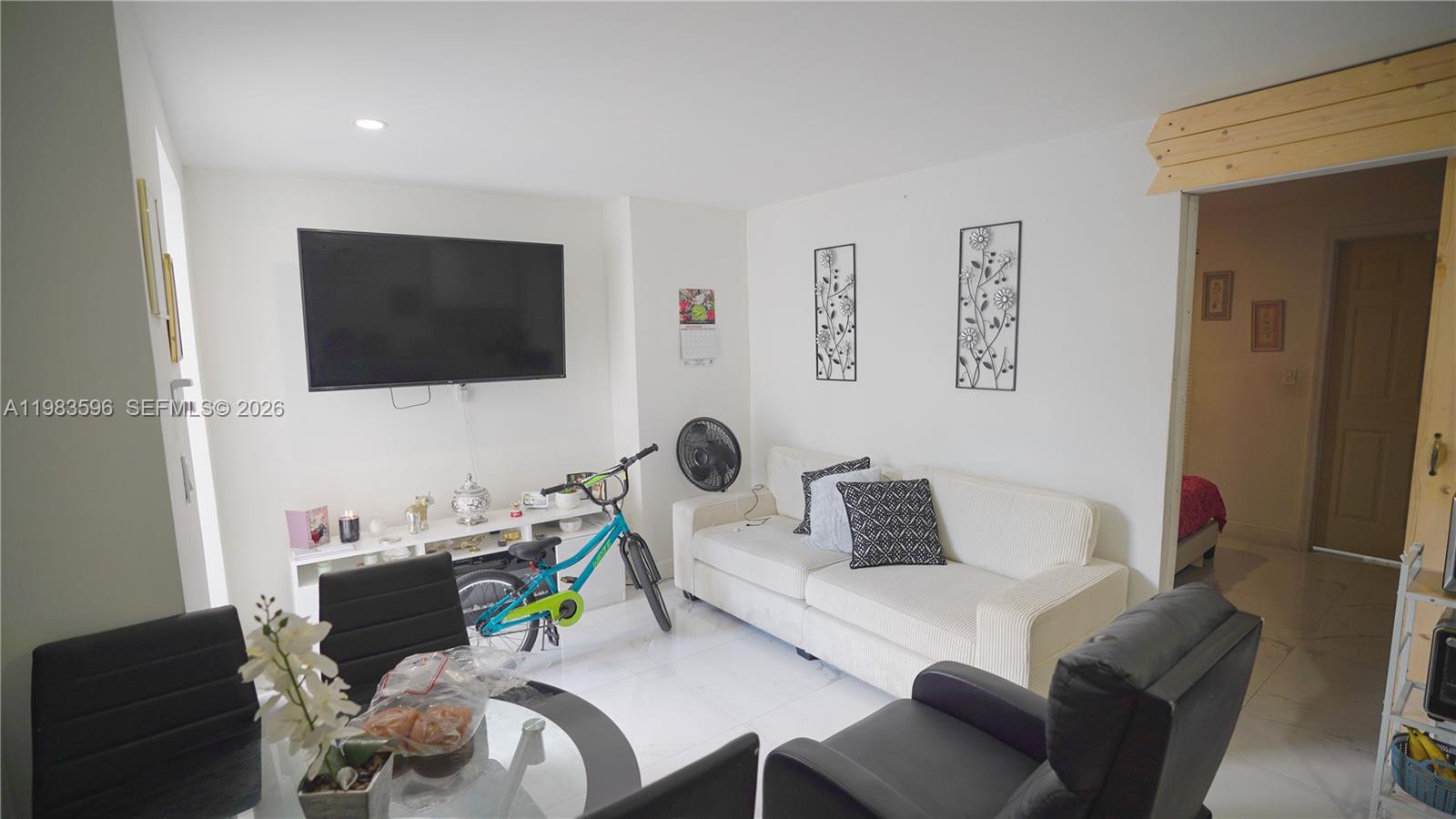 1720 Northwest 124th Terrace Miami, FL 33167 - Photo 46 of 73 a living room with furniture and a flat screen tv