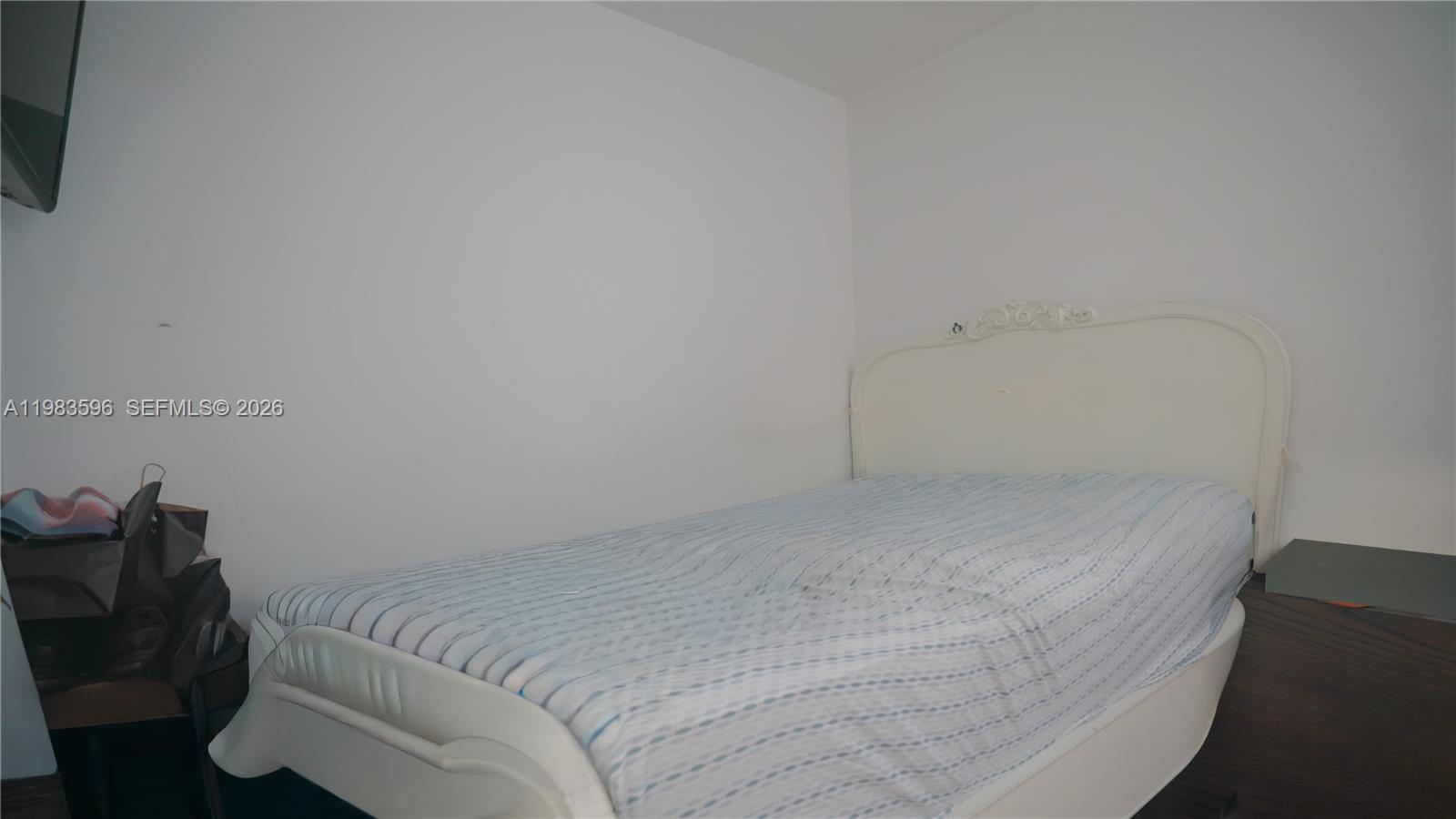 1720 Northwest 124th Terrace Miami, FL 33167 - Photo 55 of 73 a bed sitting in a bedroom next to a window