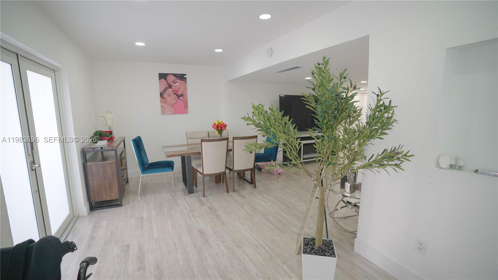 1720 Northwest 124th Terrace Miami, FL 33167 - Photo 60 of 73 a dining room with furniture and a potted plant