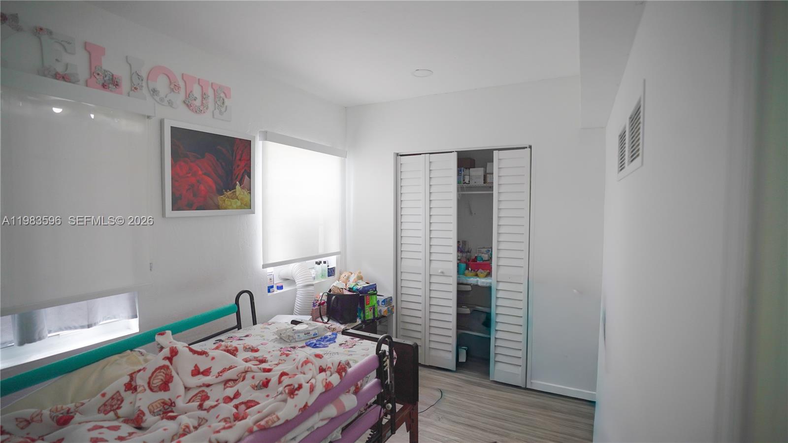 1720 Northwest 124th Terrace Miami, FL 33167 - Photo 65 of 73 a bedroom with a bed and a wooden floor