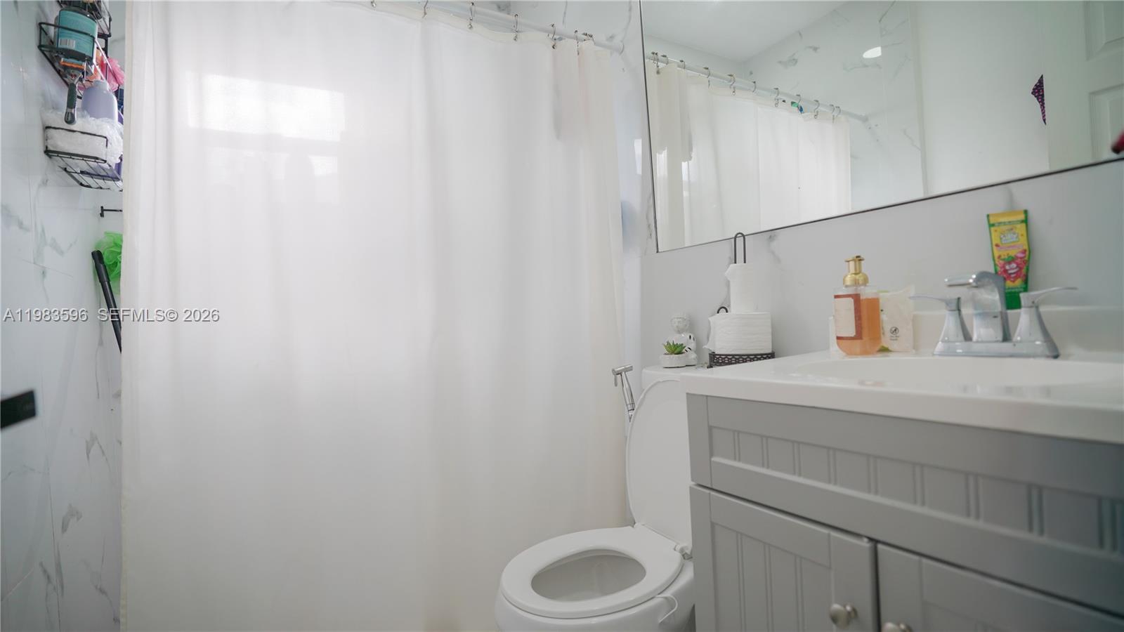 1720 Northwest 124th Terrace Miami, FL 33167 - Photo 66 of 73 a bathroom with a sink and a toilet
