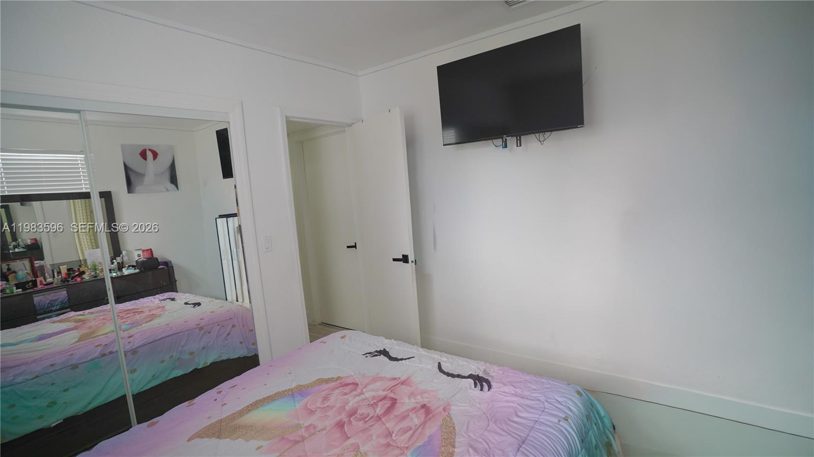 1720 Northwest 124th Terrace Miami, FL 33167 - Photo 68 of 73 a bedroom with a bed and a flat screen tv