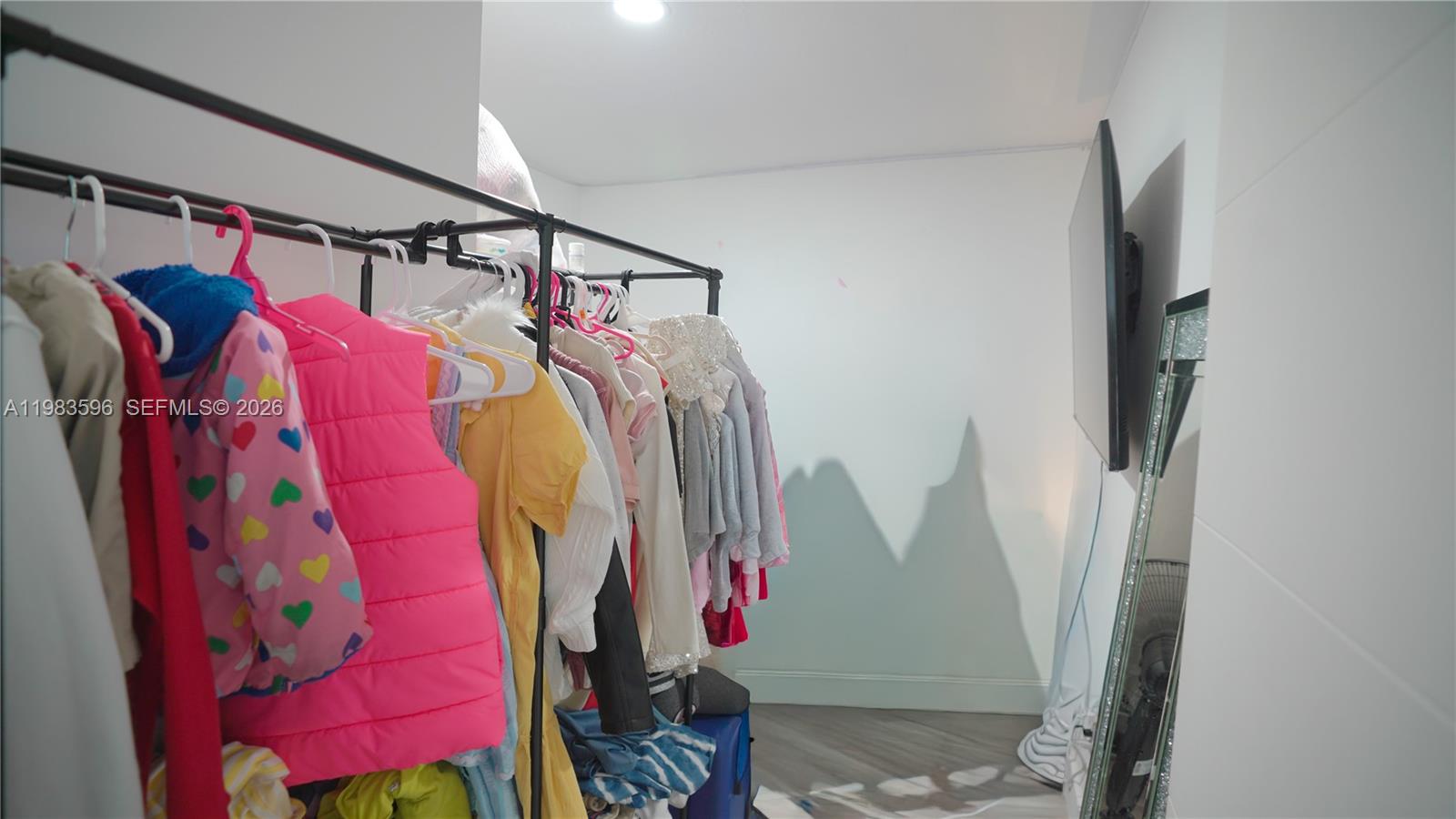 1720 Northwest 124th Terrace Miami, FL 33167 - Photo 70 of 73 a view of walk in closet with clothes and shoes