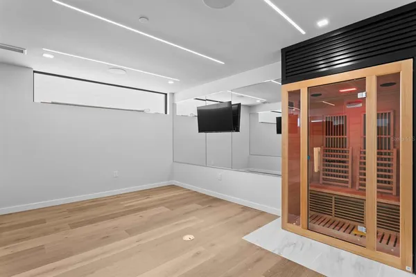 a large white kitchen with a sink stainless steel appliances and cabinets