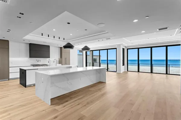 a large white kitchen with a large window