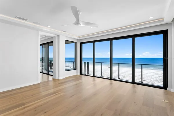 a view of an empty room with wooden floor