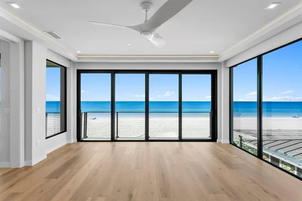 a view of a hallway with wooden floor and sliding door