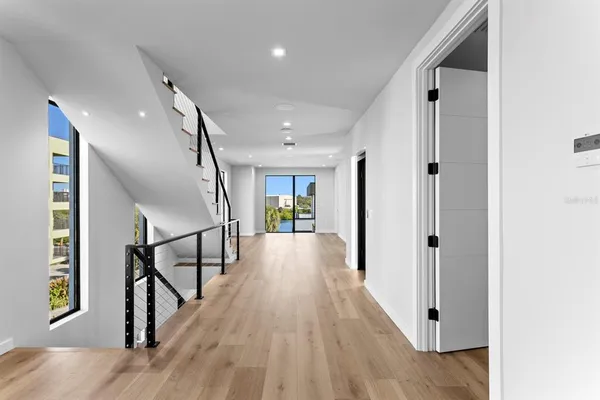 a view of a hallway with wooden door