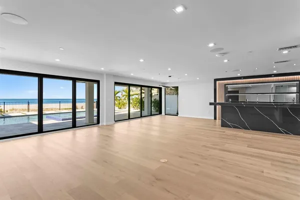 a open kitchen with stainless steel appliances granite countertop a large counter top a stove and a sink with cabinets