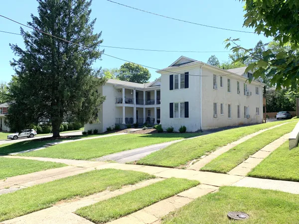 a view of a house with a yard and plants