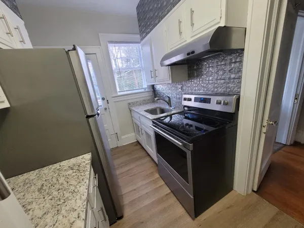 a kitchen with a refrigerator and a sink