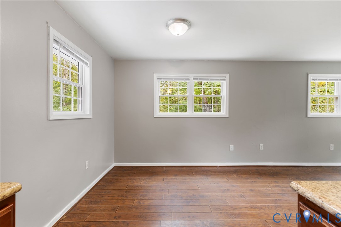 164 Kinneytown Road Mineral, VA 23117 - Photo 16 of 31 a view of an empty room with wooden floor and a window