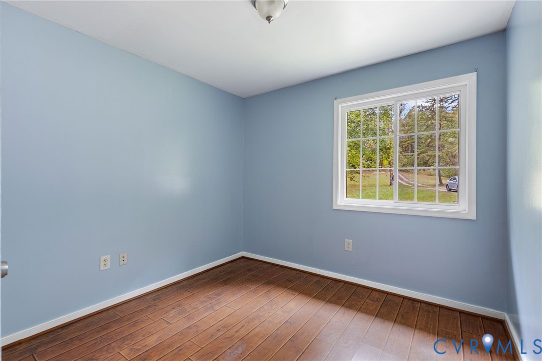 164 Kinneytown Road Mineral, VA 23117 - Photo 17 of 31 a view of an empty room with wooden floor and a window