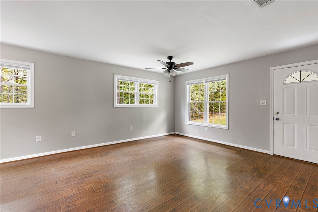 164 Kinneytown Road Mineral, VA 23117 - Photo 7 of 31 a view of an empty room with a window and wooden floor