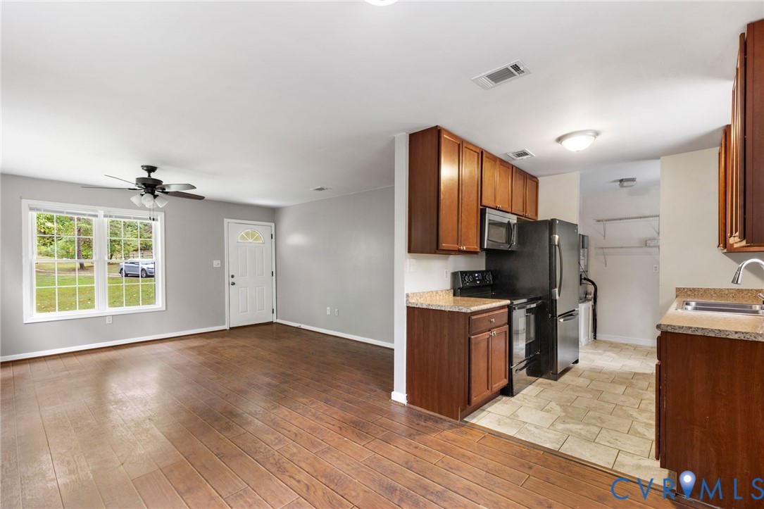 164 Kinneytown Road Mineral, VA 23117 - Photo 9 of 31 a kitchen with granite countertop a stove top oven a sink dishwasher a refrigerator and cabinets with wooden floor