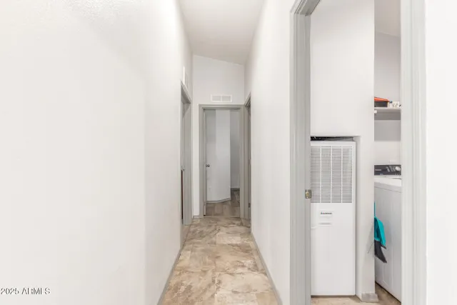 a kitchen with stainless steel appliances granite countertop a stove top oven a sink dishwasher and a microwave oven with white cabinets