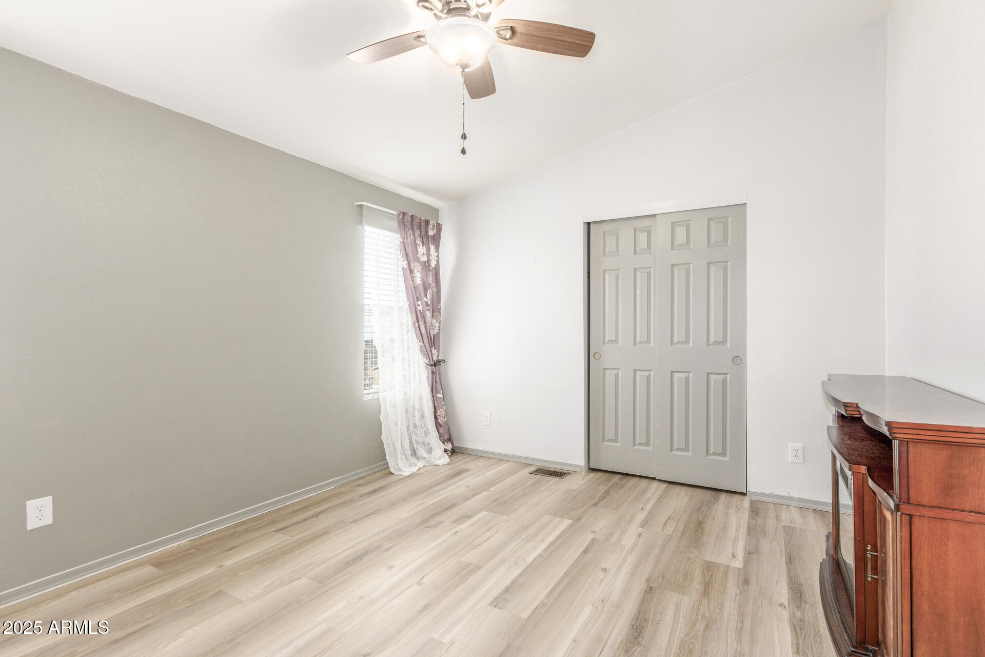 11425 East University Drive, Unit 115 Apache Junction, AZ 85120 - Photo 11 of 28 a view of empty room with wooden floor and fan