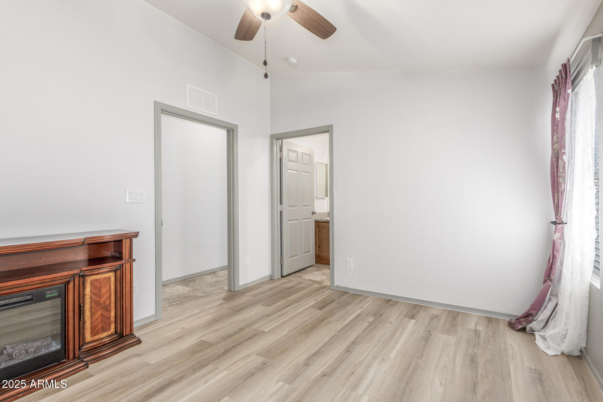 11425 East University Drive, Unit 115 Apache Junction, AZ 85120 - Photo 13 of 28 wooden floor in an empty room with a window
