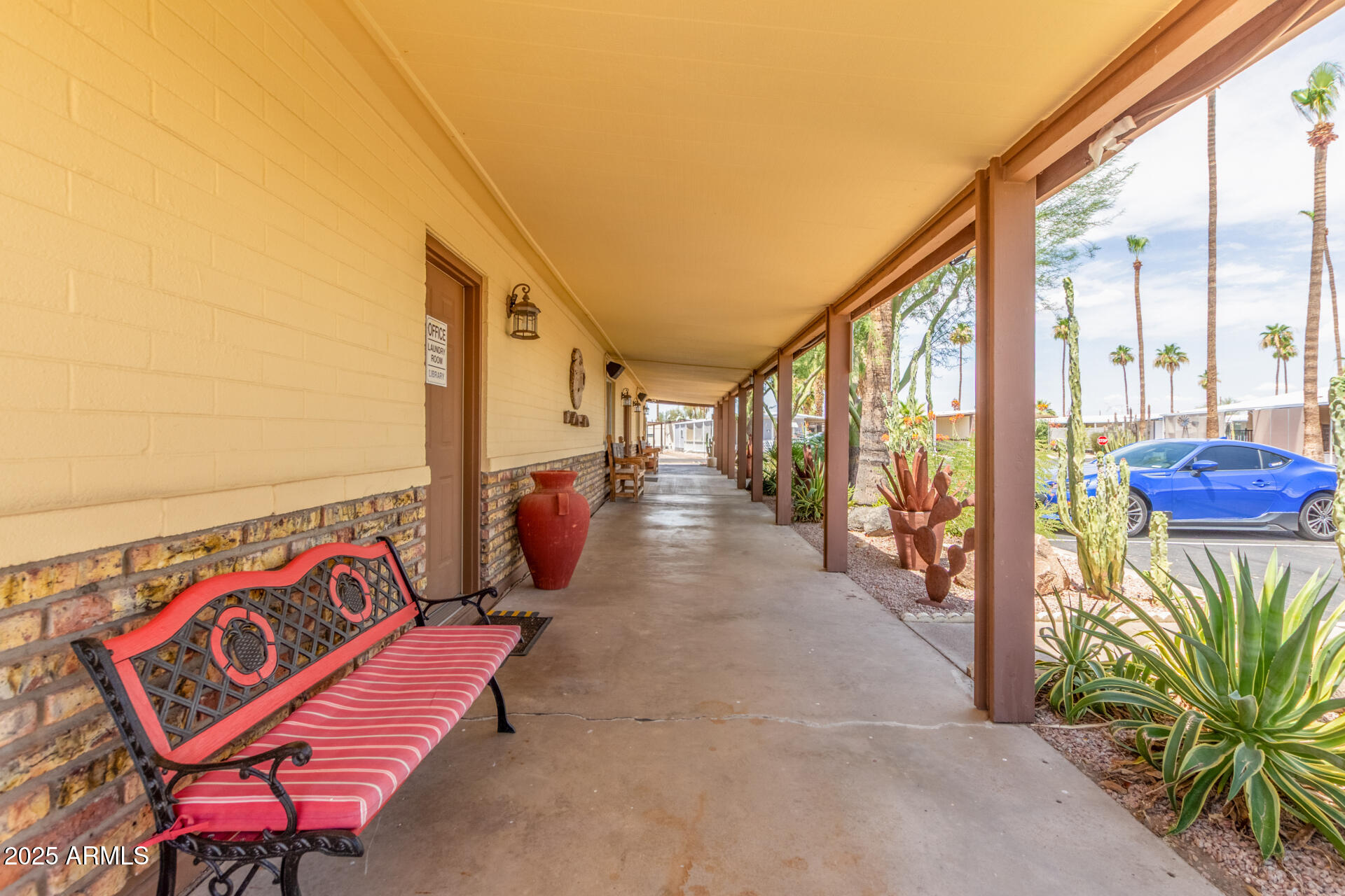 11425 East University Drive, Unit 115 Apache Junction, AZ 85120 - Photo 23 of 28 a view of a patio with wooden floor and iron fence