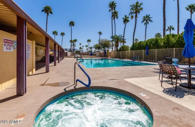 a swimming pool with outdoor seating and yard