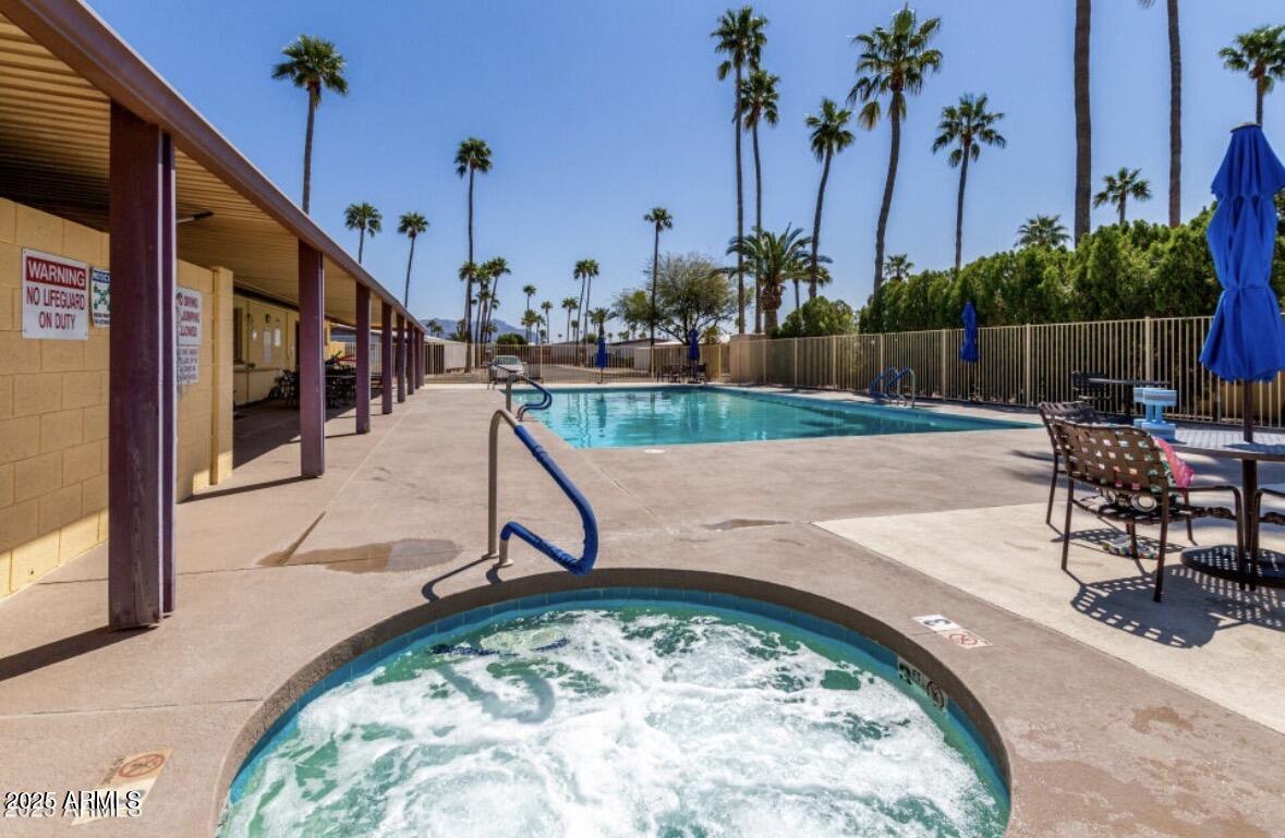 11425 East University Drive, Unit 115 Apache Junction, AZ 85120 - Photo 25 of 28 a swimming pool with outdoor seating and yard