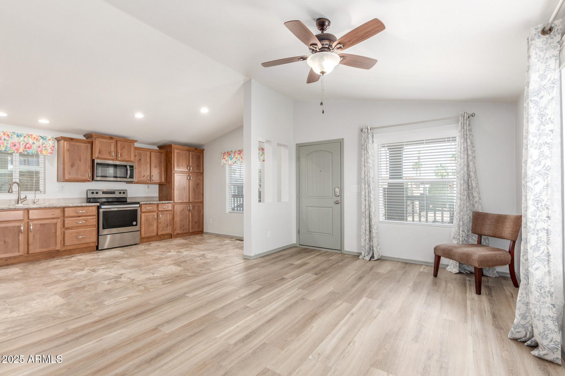 11425 East University Drive, Unit 115 Apache Junction, AZ 85120 - Photo 4 of 28 a view of a livingroom with furniture a ceiling fan and window