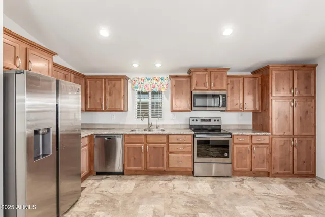 a living room with furniture kitchen view and a window