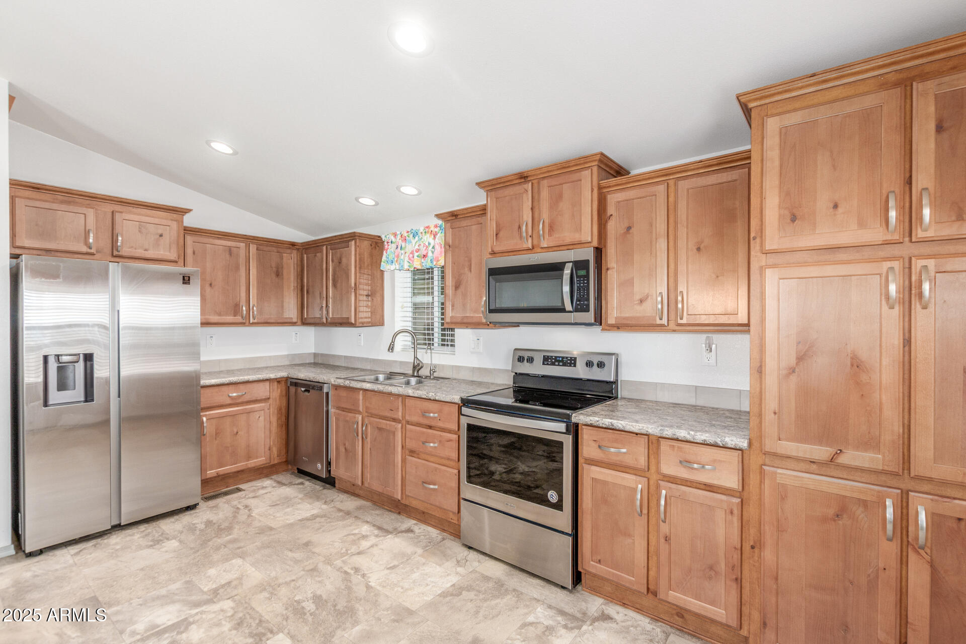 11425 East University Drive, Unit 115 Apache Junction, AZ 85120 - Photo 6 of 28 a kitchen with stainless steel appliances granite countertop a refrigerator stove top oven and sink