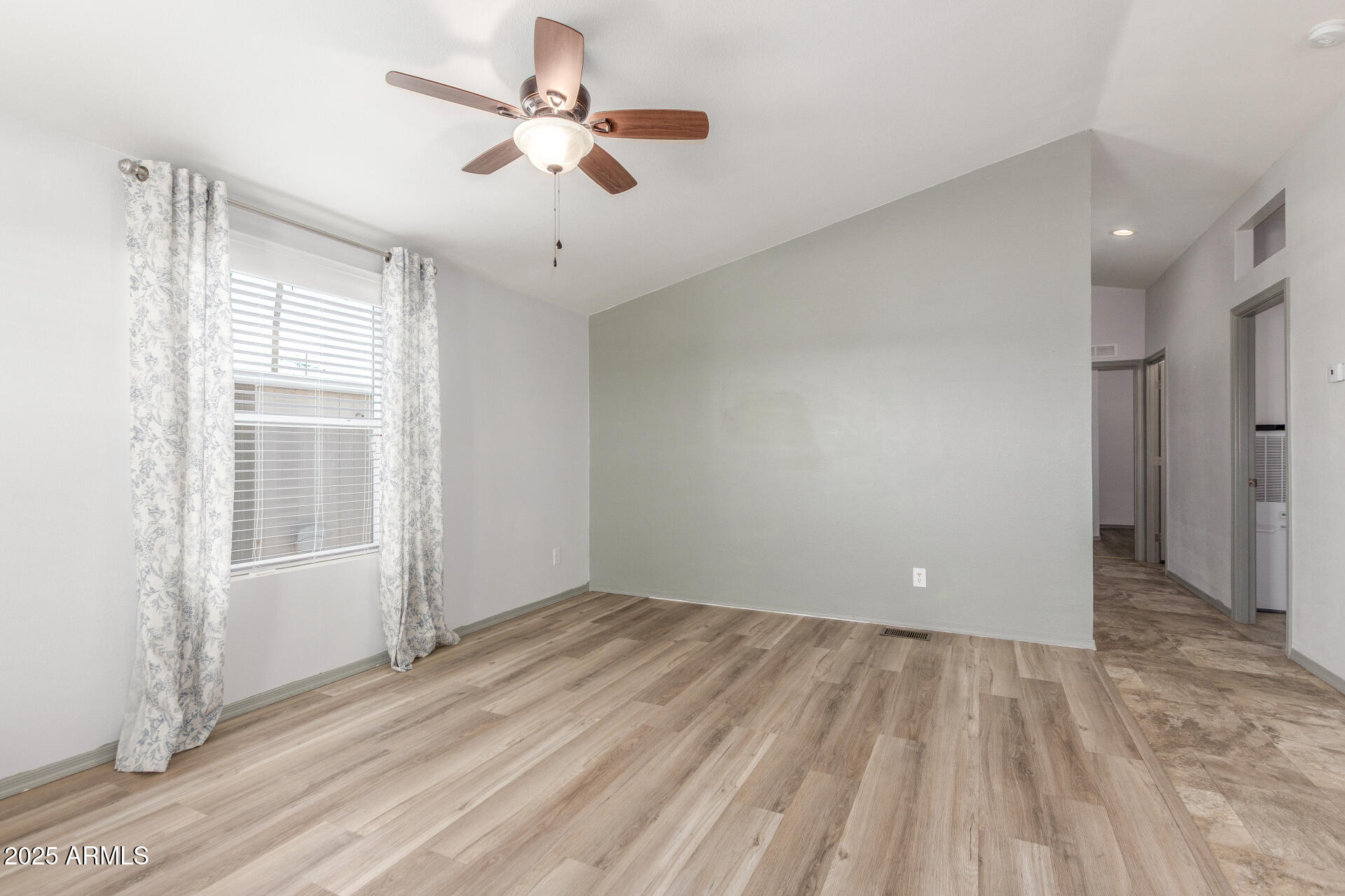 11425 East University Drive, Unit 115 Apache Junction, AZ 85120 - Photo 8 of 28 wooden floor in an empty room with a window
