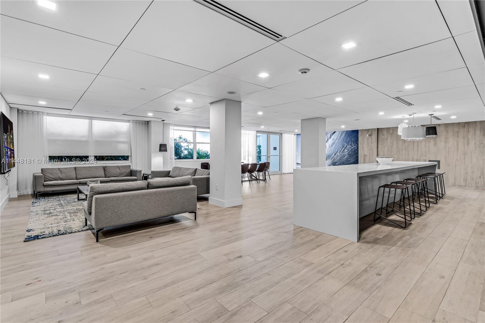 199 Ocean Ln Drive, Unit 212 Key Biscayne, FL 33149 - Photo 29 of 44 a large white kitchen with kitchen island a counter top space a sink stainless steel appliances and cabinets