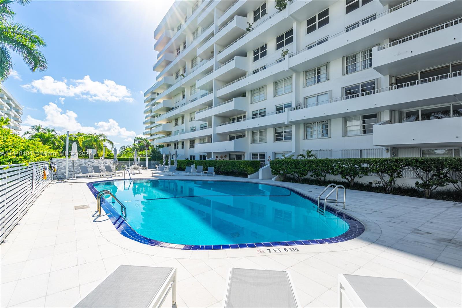 199 Ocean Ln Drive, Unit 212 Key Biscayne, FL 33149 - Photo 3 of 44 a view of a swimming pool with a garden