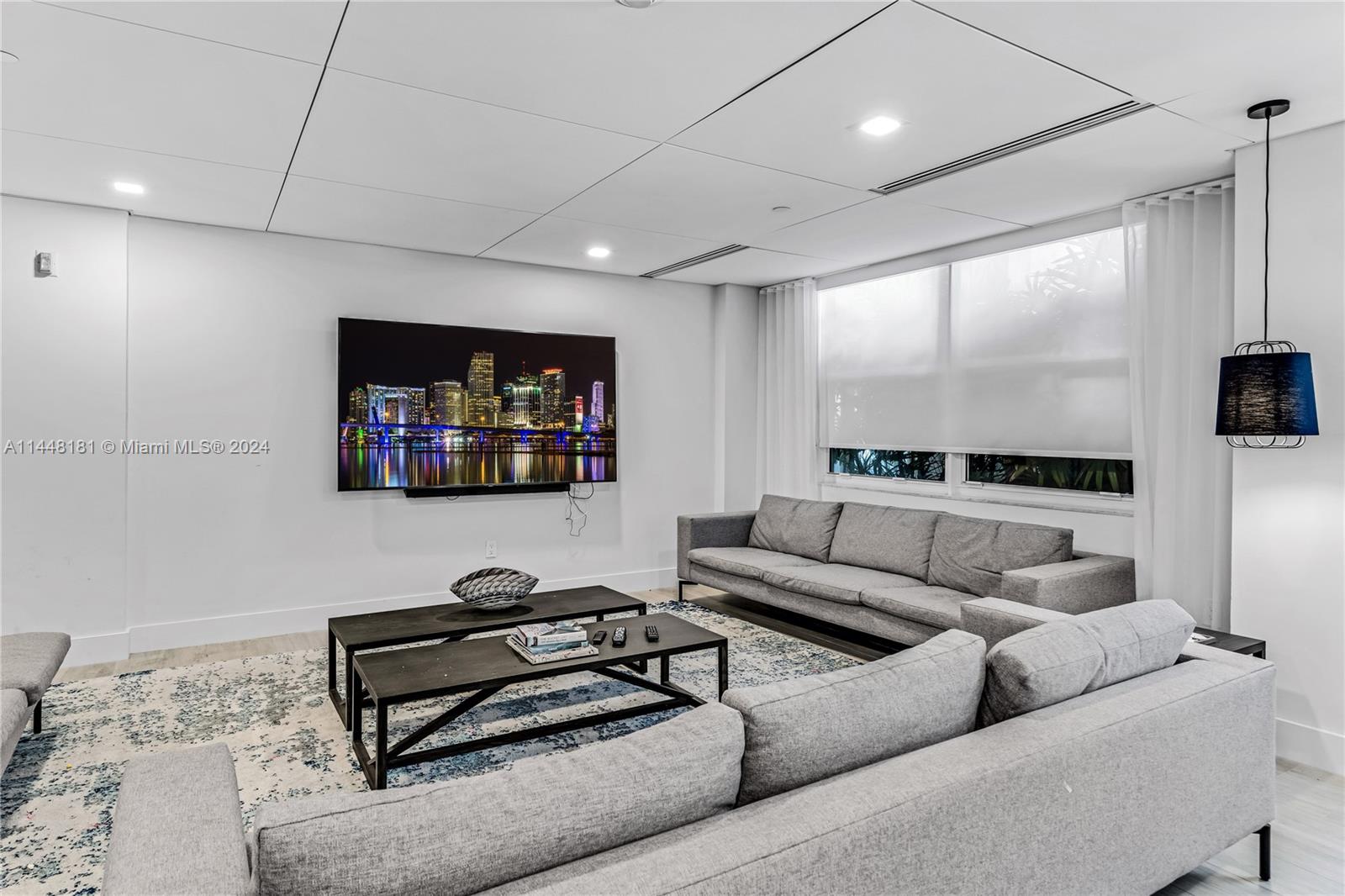 199 Ocean Ln Drive, Unit 212 Key Biscayne, FL 33149 - Photo 32 of 44 a living room with furniture and a flat screen tv