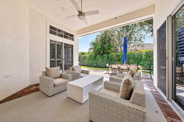a view of a house with backyard and sitting area