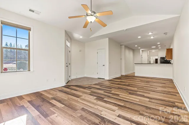 a view of a bedroom with a bed and a chandelier fan